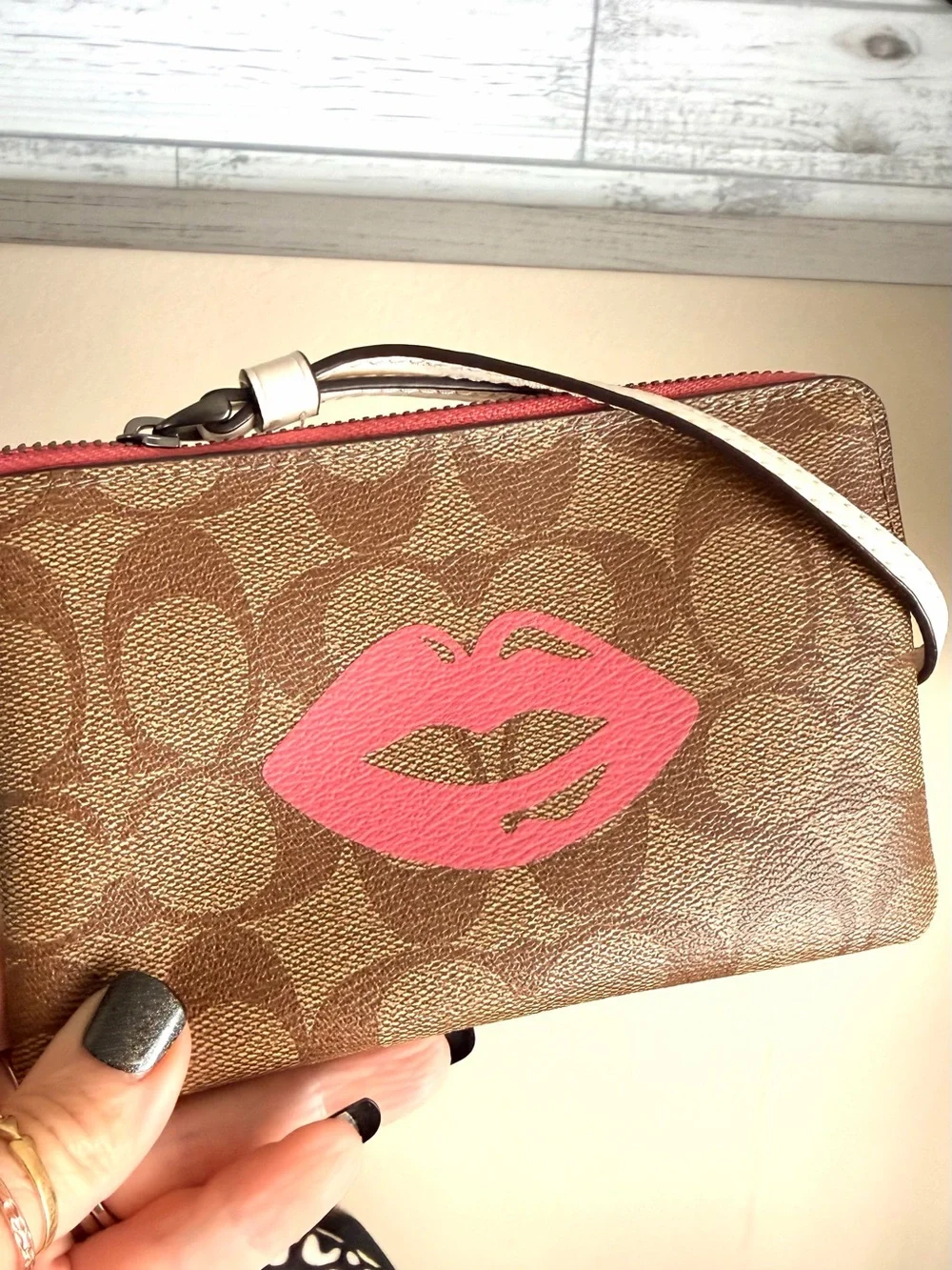 Coach Brown Signature Wristlet with Pink Lip Print near new